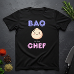 Black t-shirt with a cartoon bao bun graphic and text 'BAO to the CHEF' on a dark surface.