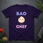 Purple t-shirt with a cartoon dumpling graphic and text on a dark surface.
