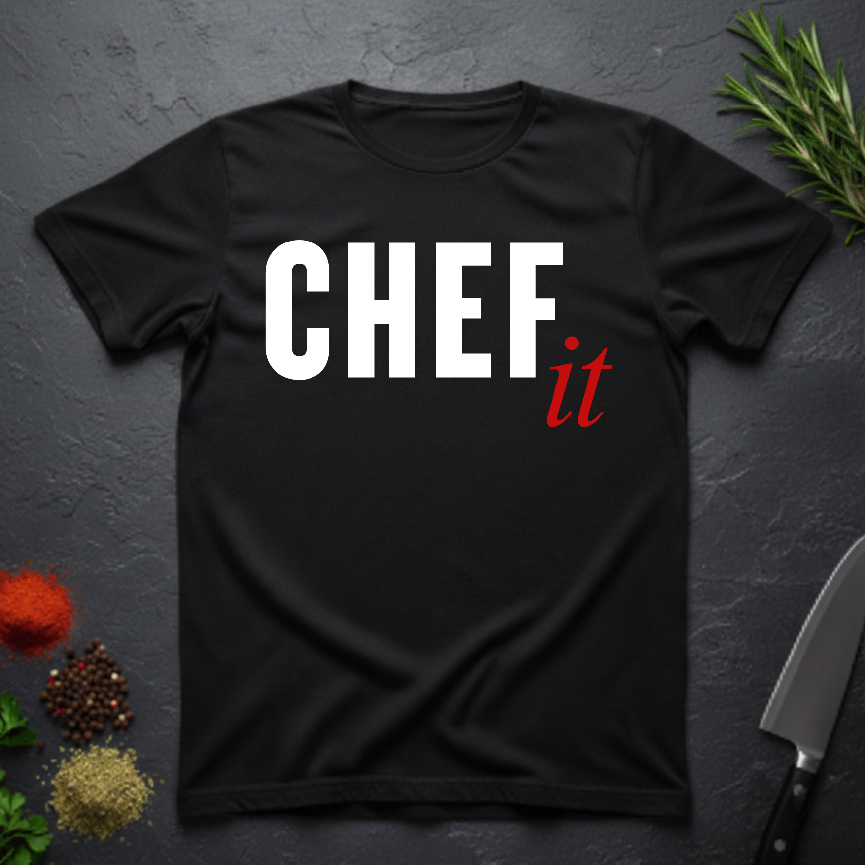 Black t-shirt with 'CHEF it' text on a dark surface with kitchen items.
