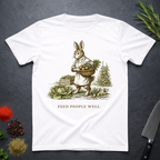 White t-shirt with a graphic of a rabbit holding a basket of vegetables and the text 'Feed People Well' on a dark surface.