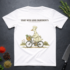 White t-shirt with a graphic of a goose chef riding a bike with vegetables in basket. Text "Start with Good Ingredients" above graphic. 