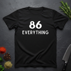 Black t-shirt with '86 Everything' text on a dark surface with decorative elements.