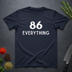 Navy blue t-shirt with '86 Everything' text on a dark surface with decorative elements.