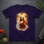 Purple t-shirt with a graphic of a chef Jesus holding a spoon and a cross on a dark surface.