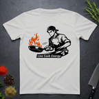 White t-shirt with a graphic of a chef and 'Line Cook Energy' text on a dark surface.