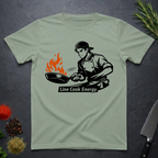 Sage Green t-shirt with a graphic of a chef and 'Line Cook Energy' text on a dark surface.