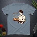 Stone Blue t-shirt with a graphic of a baker holding bread and text 'Up Before Dawn' on a dark surface.