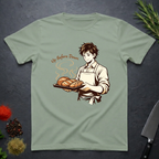 Sage Green t-shirt with a graphic of a baker holding bread and text 'Up Before Dawn' on a dark surface.
