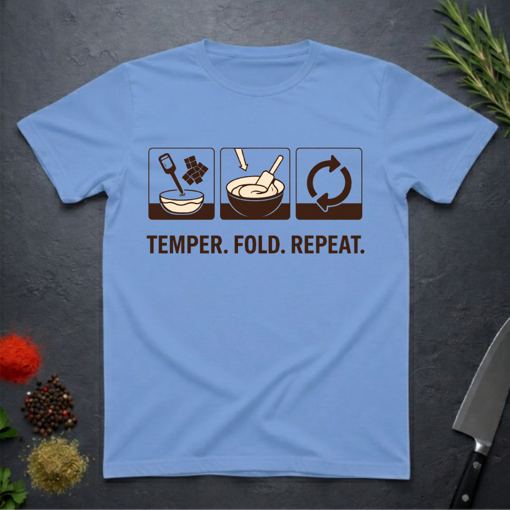 Carolina blue t-shirt with chocolate-making diagram and text 'Temper. Fold. Repeat.' on a dark surface.