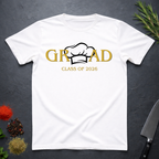 White t-shirt with gold text 'GRAD Class of 2026' and a centered Chef's Toque design on a dark surface with decorative elements.