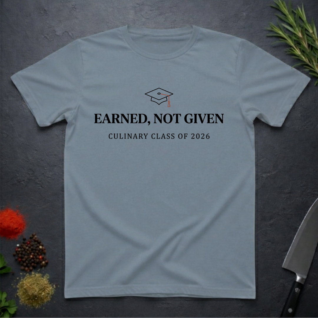 Stone Blue t-shirt with 'Earned, Not Given Culinary Class of 2026' text on a dark surface.