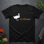Black t-shirt with a white duck graphic and 'a l'Orange' text on a dark surface.
