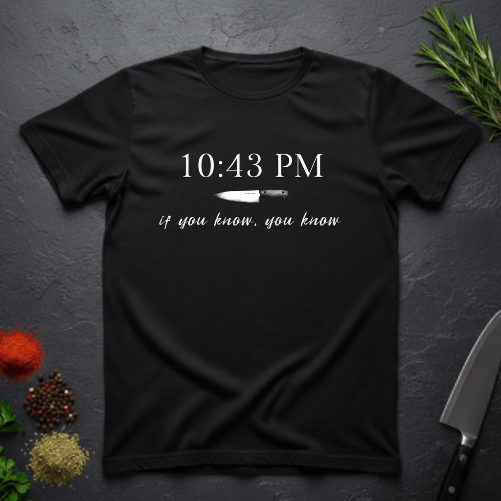 Black t-shirt with knife graphic and text "10:43 PM - if you know, you know" on a dark surface.
