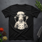 Black t-shirt with a graphic of a chef goat holding cooking utensils on a dark surface.