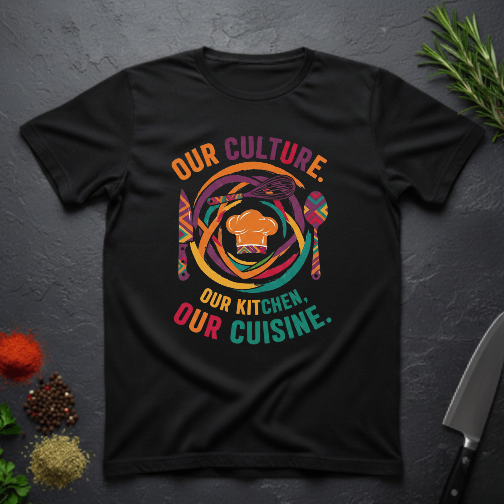 Black t-shirt with colorful African graphic and text "Our Culture Our Kitchen, our Cuisine: on a dark surface.