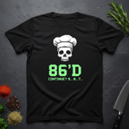 Black t-shirt with a skull wearing a chef's hat and text "86'd Continue? 9...8....7..." on a dark surface.