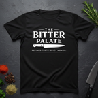 Black t-shirt with 'The Bitter Palate' logo on a dark surface with kitchen items.