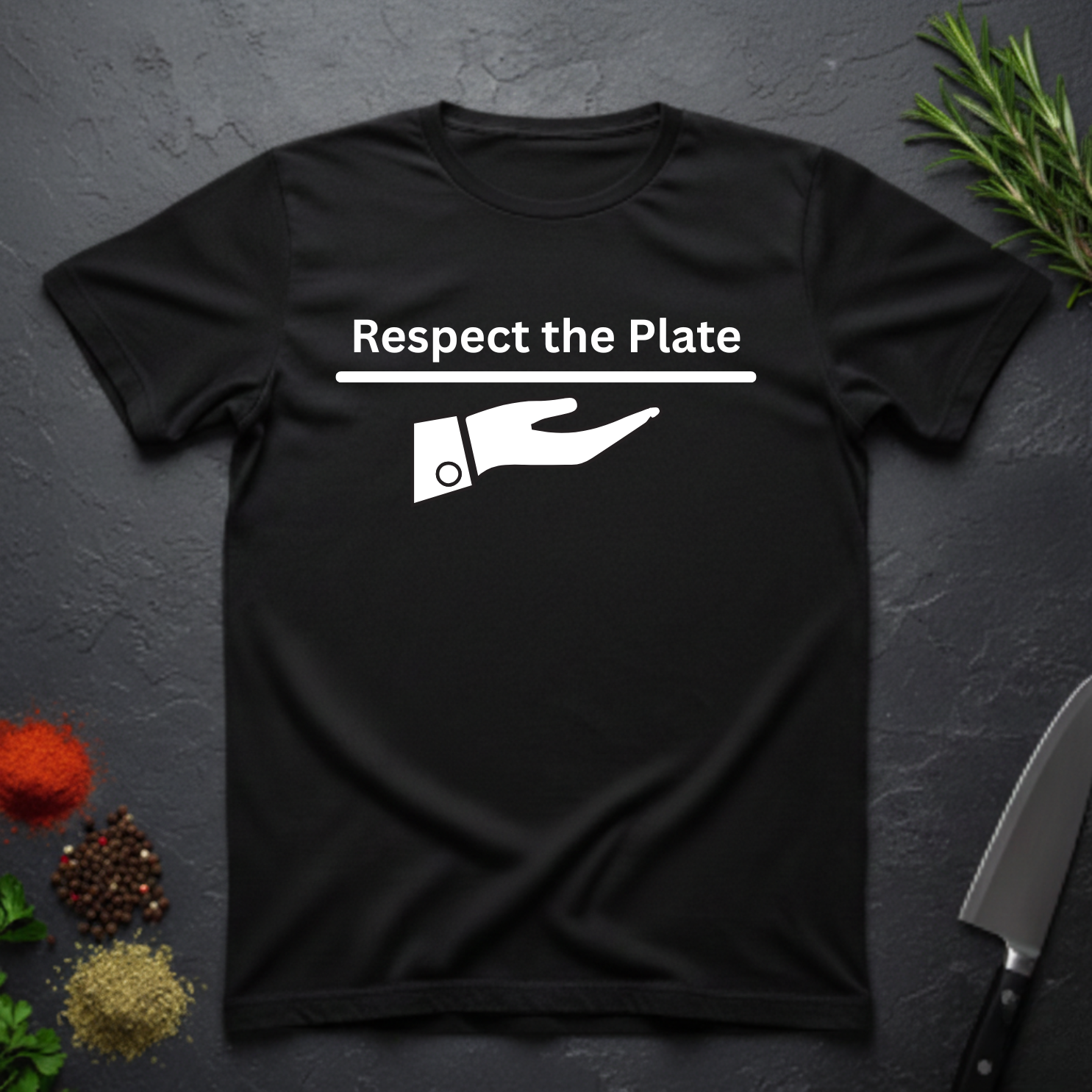 Black t-shirt with 'Respect the Plate' graphic on a dark surface with kitchen items.