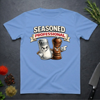 Carolina Blue t-shirt with cartoon salt and pepper shakers and 'Seasoned Professional' text on a dark surface.