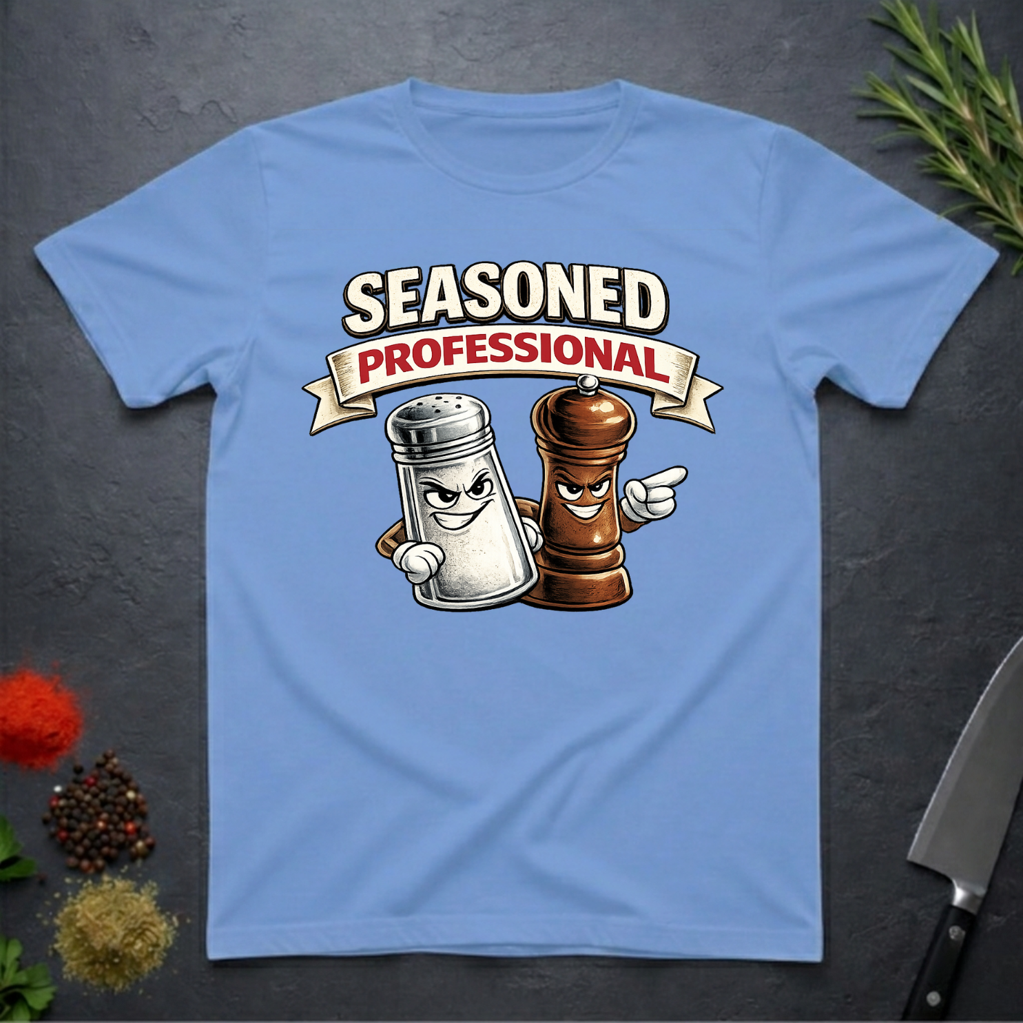 Carolina Blue t-shirt with cartoon salt and pepper shakers and 'Seasoned Professional' text on a dark surface.