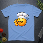 Carolina Blue t-shirt with a chef kiss emoji design on a dark surface with kitchen items.