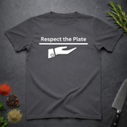 Charcoal Gray t-shirt with 'Respect the Plate' graphic on a dark surface with kitchen items.