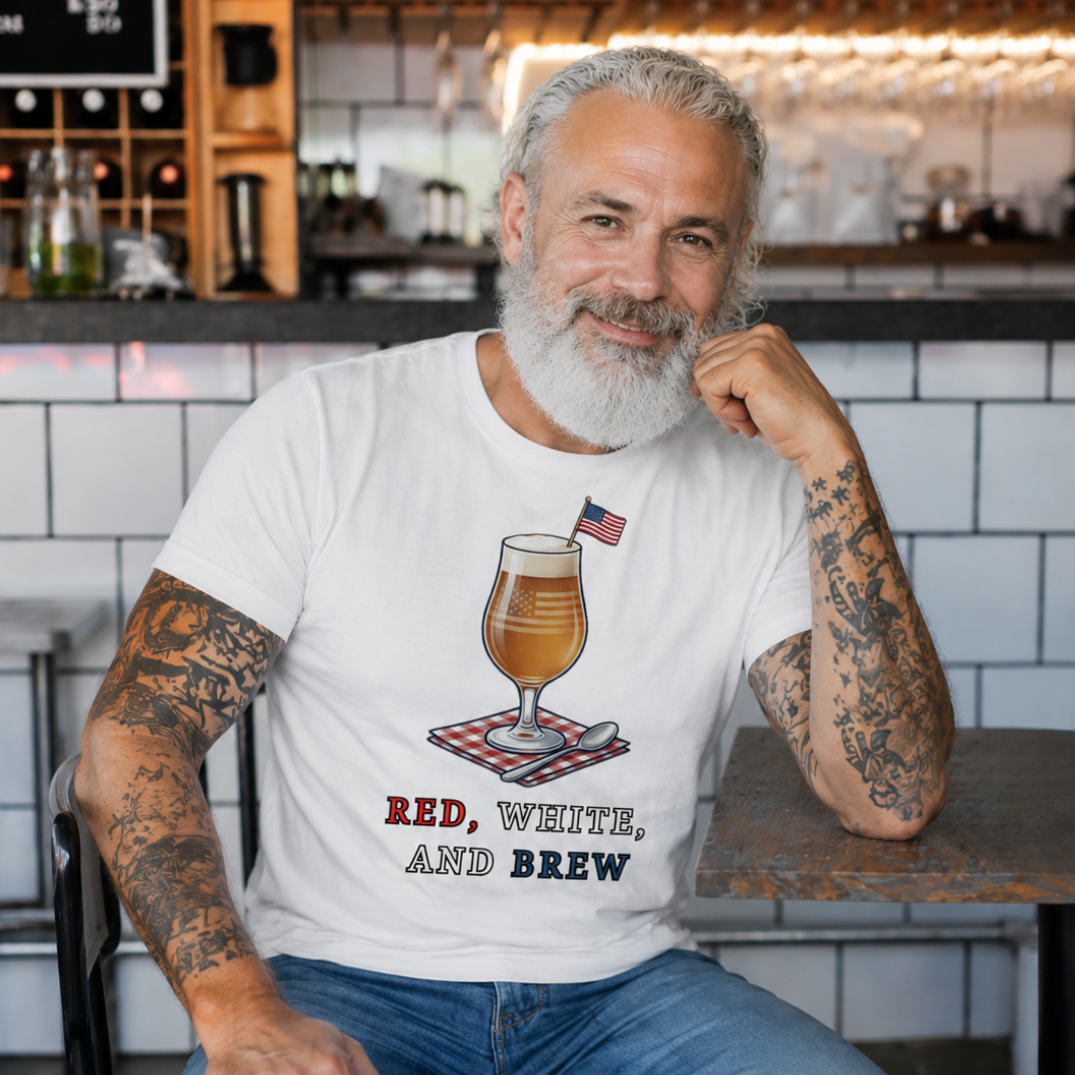 Man sitting in a bar wearing a t-shirt with a beer graphic and text.