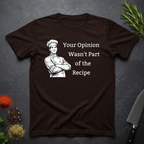Chocolate brown t-shirt with a male chef graphic and text "Your Opinion Wasn't Part of the Recipe" on a dark surface with kitchen items.