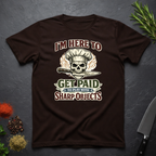 Chocolate brown t-shirt with skull and knife graphic and text "I'm Here to Get Paid the Play with Sharp objects" on a dark surface