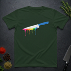 Forest green t-shirt with a chef's knife with rainbow colored drip design on a dark surface.