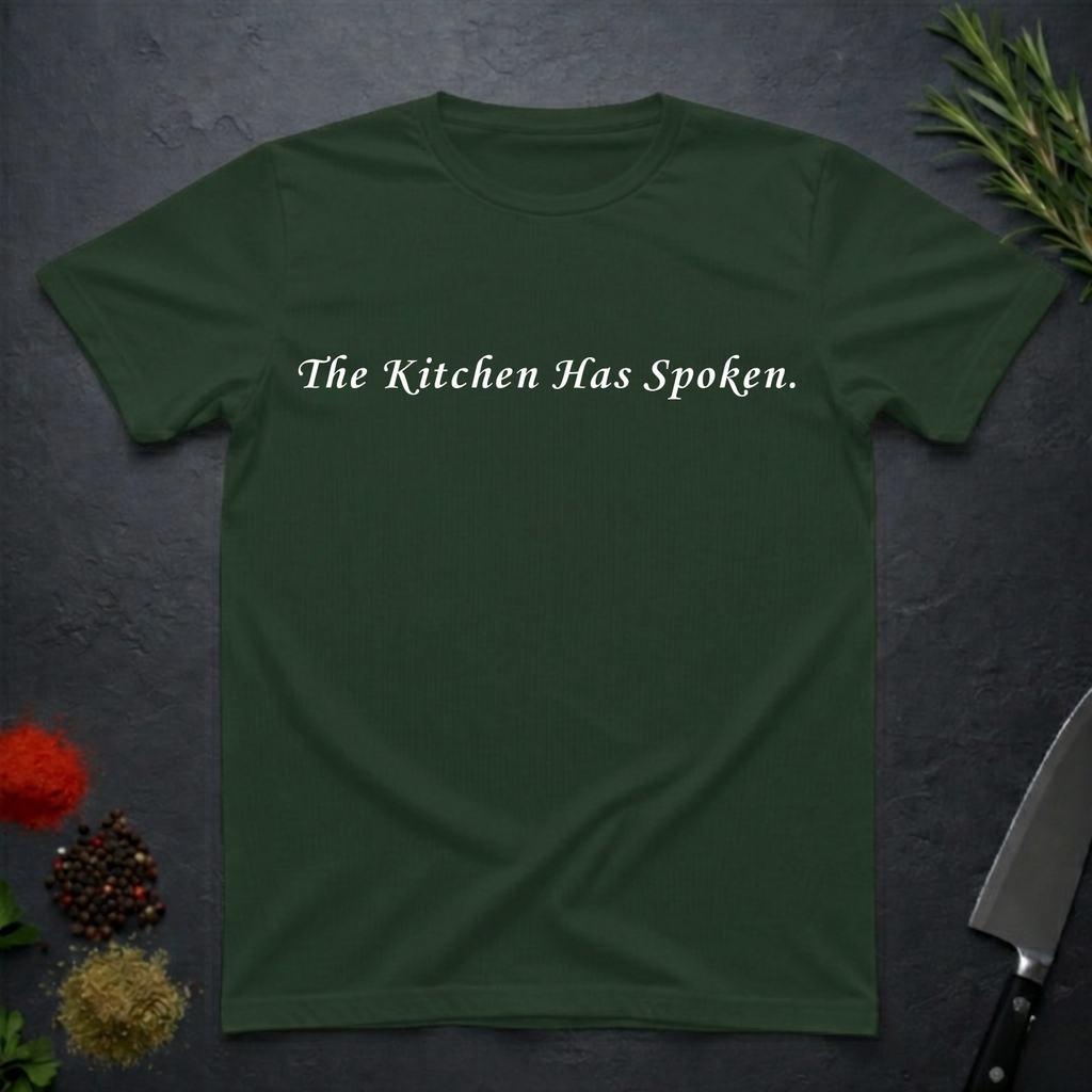 Forest Green t-shirt with 'The Kitchen Has Spoken.' text on a dark surface with kitchen items.