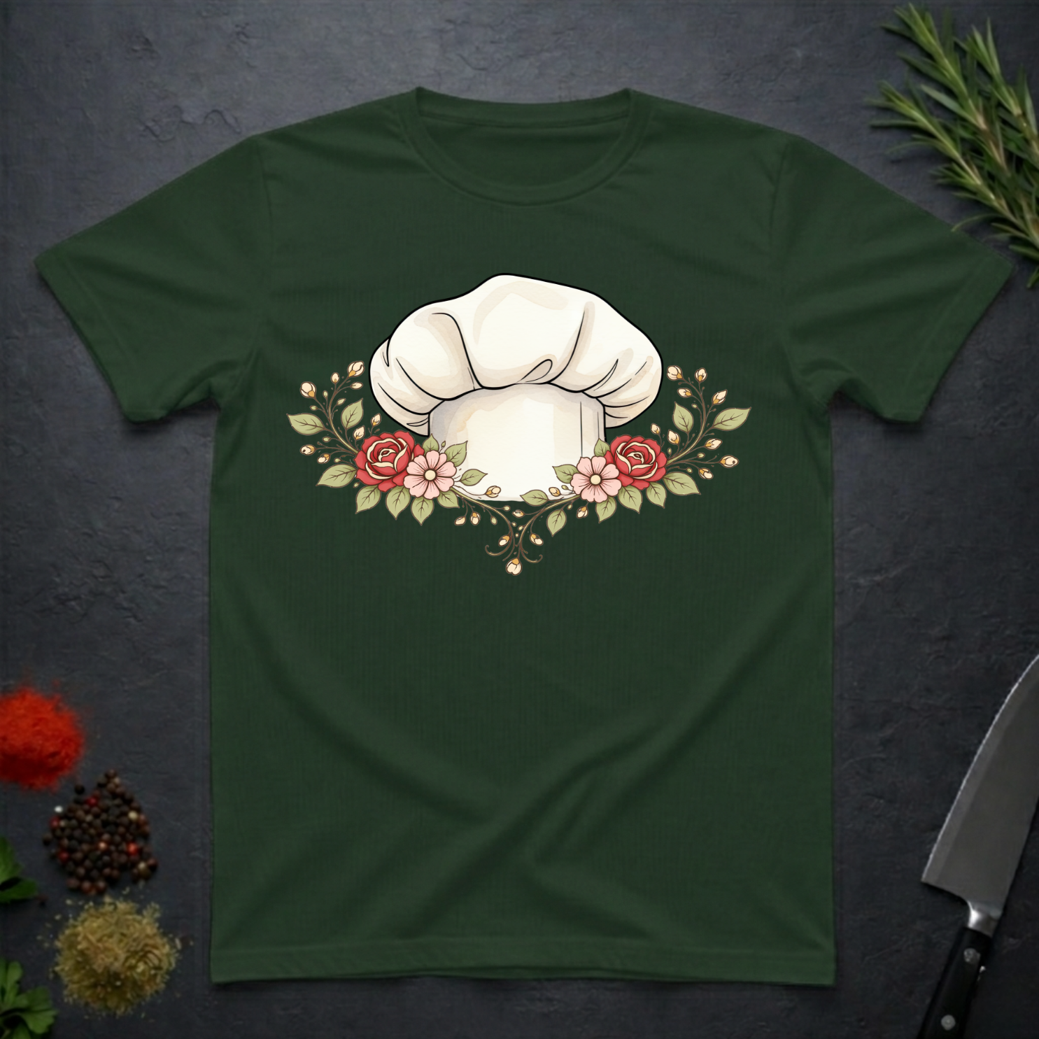 Forest Green t-shirt with a chef's hat and floral design on a dark surface.