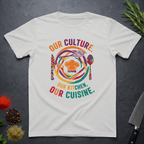 Ice grey t-shirt with colorful African graphic and text "Our Culture Our Kitchen, our Cuisine: on a dark surface.