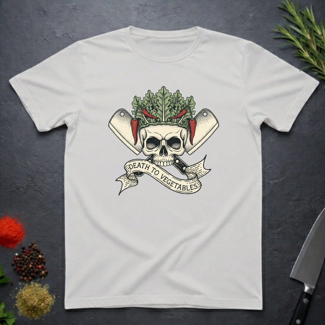Ice grey t-shirt with skull and crossed knives with vegetables design with text "Death To Vegetable" on a dark surface.