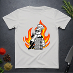 Ice grey t-shirt with a cartoon dead-pan chef leaning on text books with a background of flames on a dark surface.