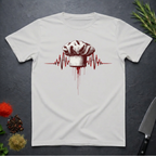 Ice Grey t-shirt with a chef hat and heartbeat design on a dark surface with kitchen items.