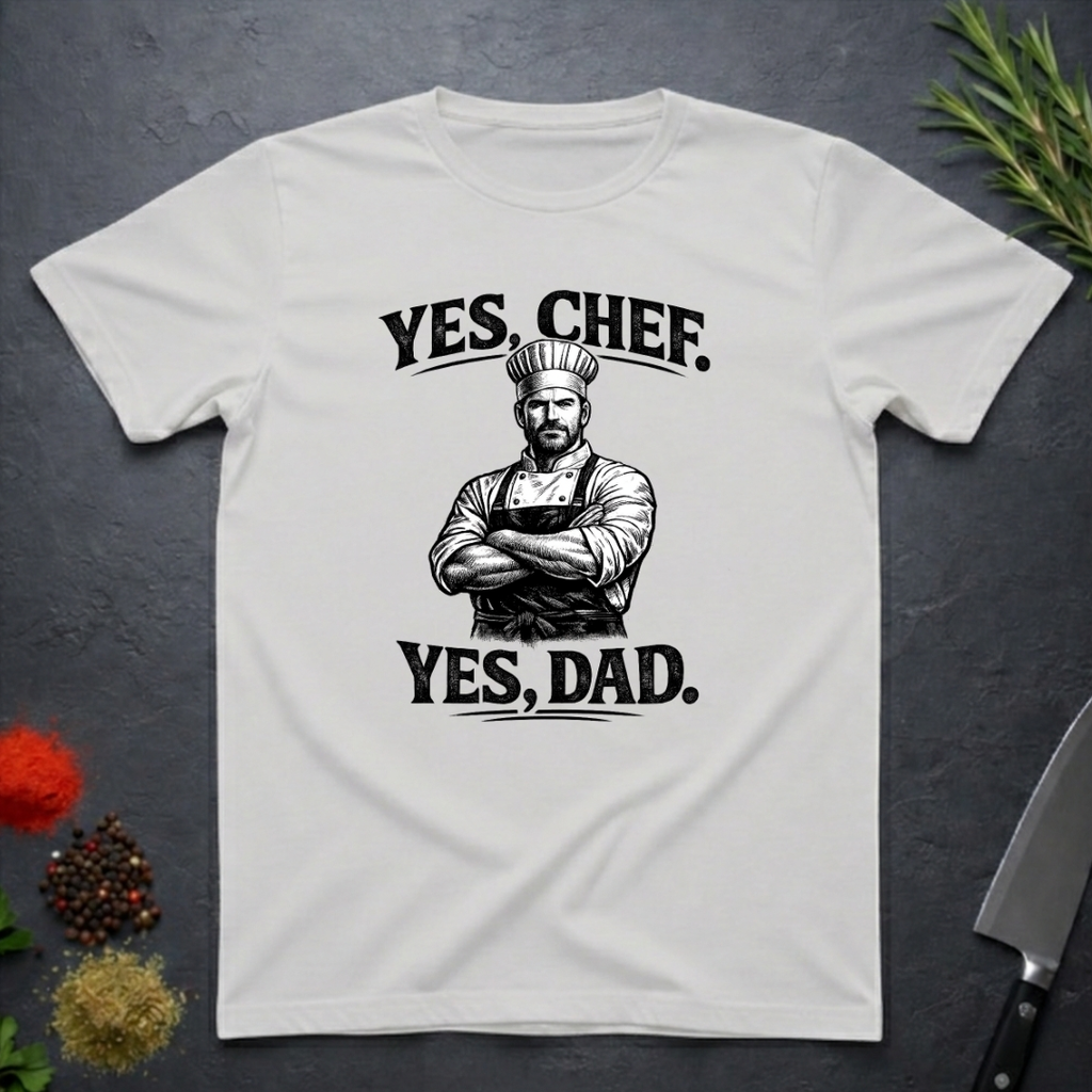 Ice Grey t-shirt with a graphic of a chef and text 'YES, CHEF. YES, DAD.' on a dark surface.