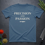 Indigo Blue t-shirt with 'PRECISION AND PASSION' text on a dark surface with kitchen items.