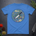 Iris blue t-shirt with a circular knife and colored floral design on a dark surface.