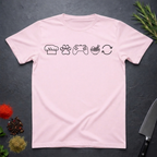 Light pink t-shirt with black icons of chef hat, paw print, game remote, ramen bowl and repeat symbol on a dark surface.