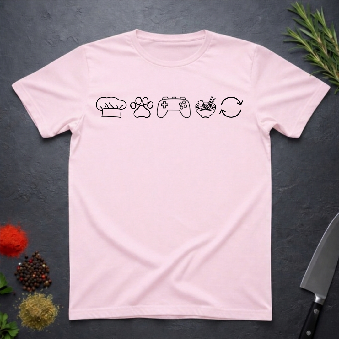 Light pink t-shirt with black icons of chef hat, paw print, game remote, ramen bowl and repeat symbol on a dark surface.