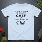 Light Blue t-shirt for Father's with text "In the kitchen we call him Chef - At home we call him Dad" on a dark surface.