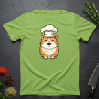 Lime green t-shirt with an orange cartoon cat wearing a chef's hat on a dark surface.