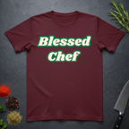 Maroon t-shirt with 'Blessed Chef' text on a dark surface with kitchen items.