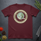 Maroon t-shirt with circular graphic of a globe and text "A Chef Blends All Cultures" on a dark surface.