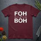 Maroon t-shirt with 'FOH / BOH' text on a dark surface with decorative elements.