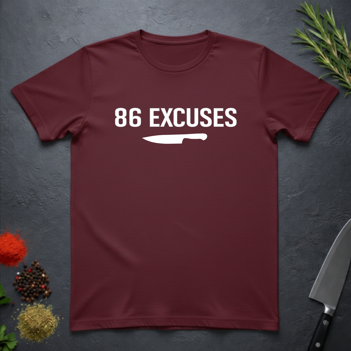 Maroon t-shirt with '86 Excuses' and a knife graphic on a dark surface.
