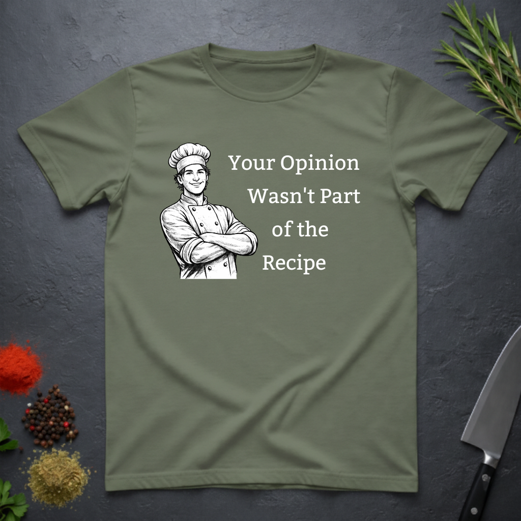 Military green t-shirt with a male chef graphic and text "Your Opinion Wasn't Part of the Recipe" on a dark surface with kitchen items.