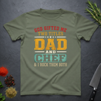 Military green t-shirt with colorful text design "God Gifted me Two Titles, Dad and Chef" on a dark surface.