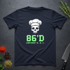 Navy blue t-shirt with a skull wearing a chef's hat and text "86'd Continue? 9...8....7..." on a dark surface.
